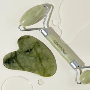 Jade-green gua sha stone and facial roller with silver handle