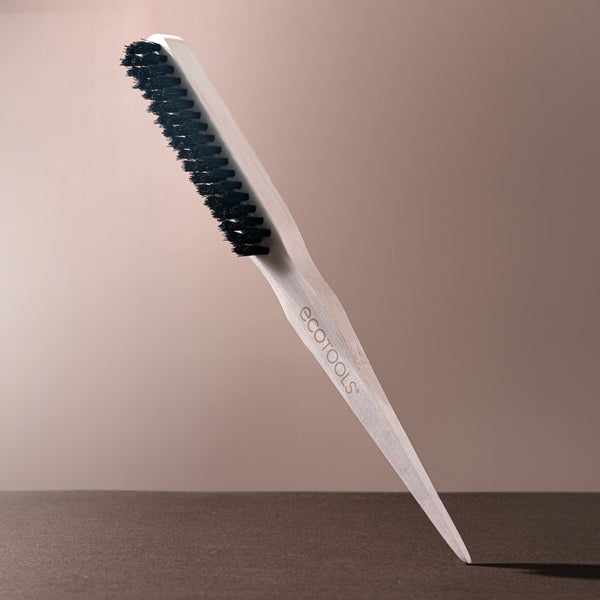 Slick back brush with cream handle and dense black bristles for styling hair