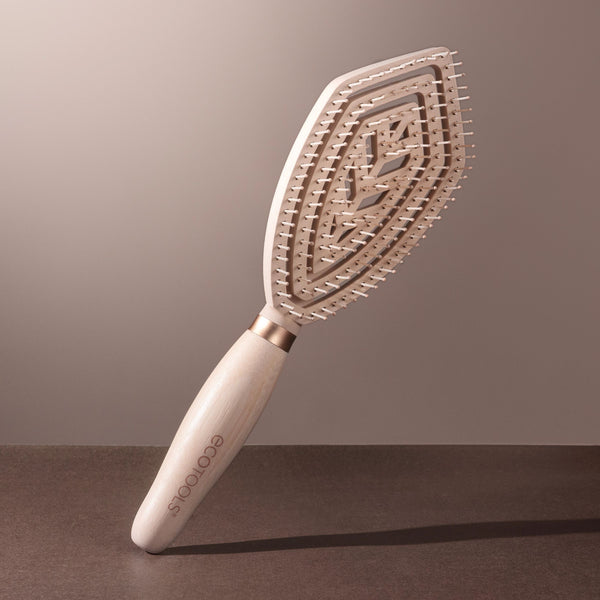 Fine hair detangler paddle brush with light wood handle and gold-toned bristles