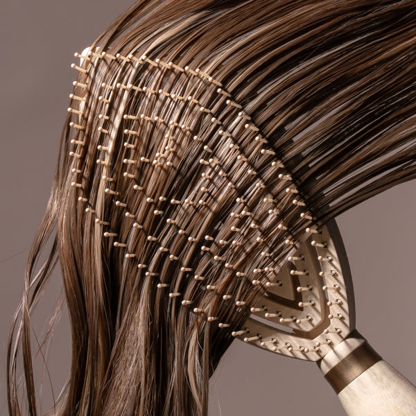 Fine hair detangler paddle brush detangling thick strands of dark brown hair