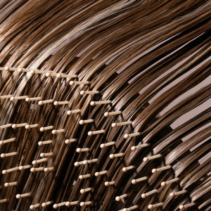 Fine hair detangler bristles detangling dark brown hair strands with flexible pin rows