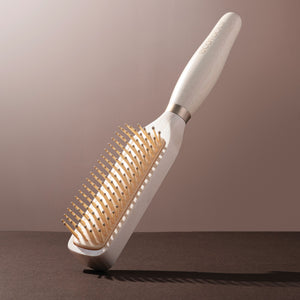 Curl activating detangler brush with light wood handle and golden pin bristles