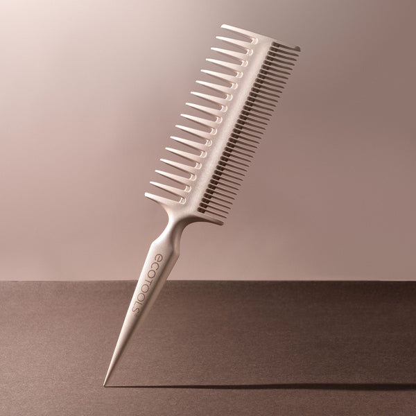 Double-sided hair comb with long and short teeth on a light-colored handle
