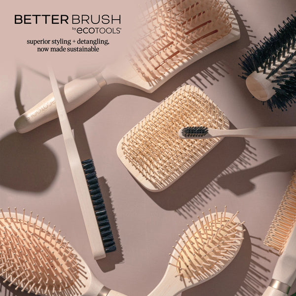 Assorted round hair brushes with light handles and black or tan bristles in a flat lay