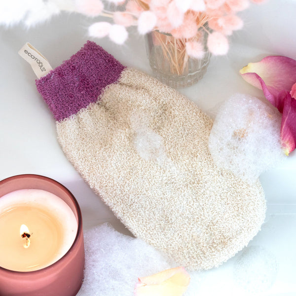Textured beige bath mitt with dark grey cuff, shown with hanging tag