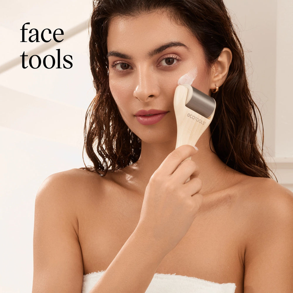 Woman applying face cream with an ecotools applicator, text face tools on a light background