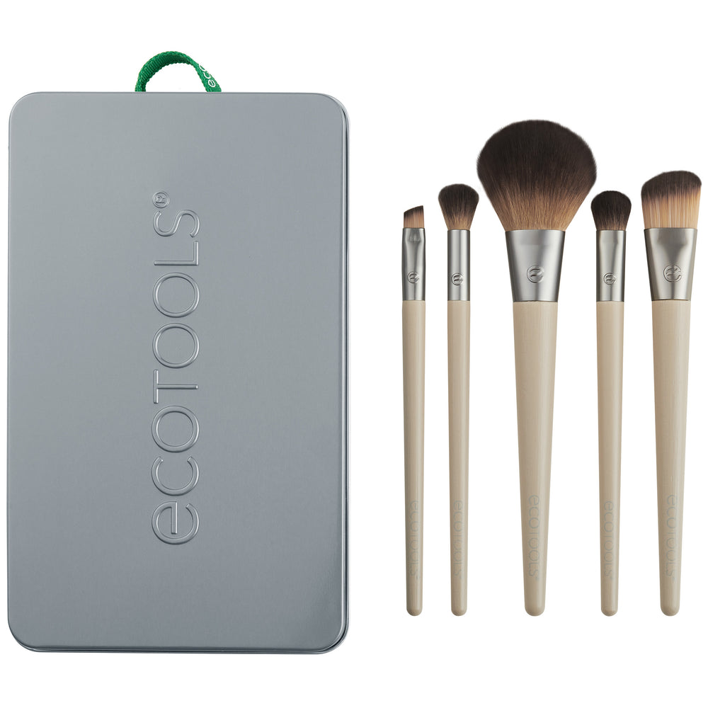 Makeup brush kit: five brushes with beige handles and brown bristles beside gray tin case