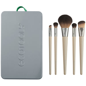 Makeup brush kit: five brushes with beige handles and brown bristles beside gray tin case