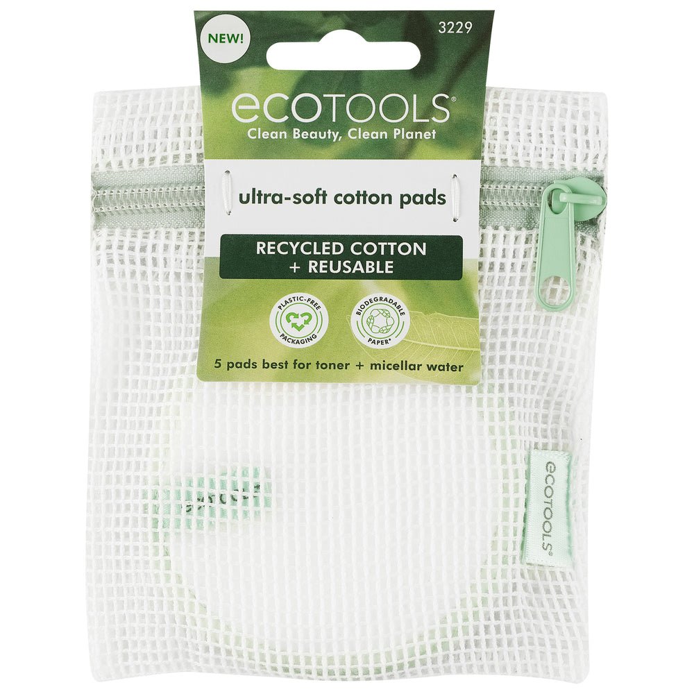 Stacked white cotton pads and round pads with green stitched edging