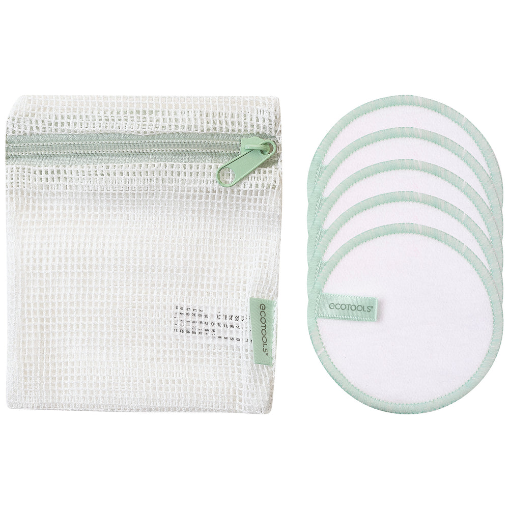 Stacked white cotton pads and round pads with green stitched edging