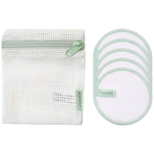 Stacked white cotton pads and round pads with green stitched edging