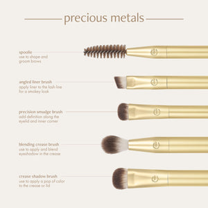 Five gold eye brushes with dark brown bristles, including spoolie and smudge brush.