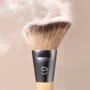 Single makeup brush with dense brown bristles and matte silver collar for highlighting