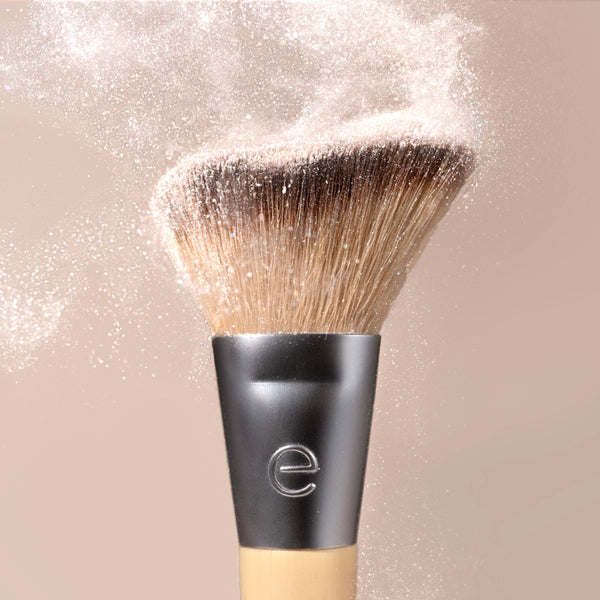 Single makeup brush with dense brown bristles and matte silver collar for highlighting