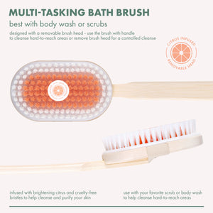 Round bath brush head with orange bristles and a removable white scrub head