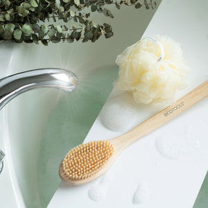 Bath brush with oval natural bristle head and bamboo handle, ecotools branding visible.