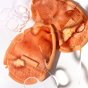Close-up of orange teardrop facial cleansing cloths with textured cleaning side