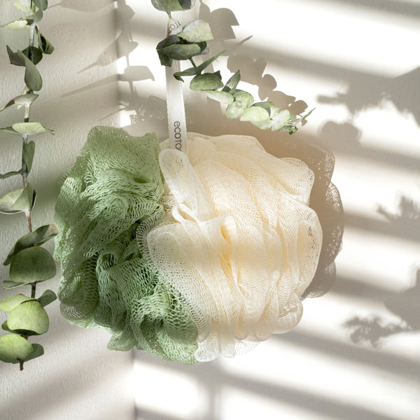 Green and cream exfoliating bath loofah pouf with hanging loop