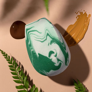 Green-and-white marble teardrop makeup sponge blender for applying foundation