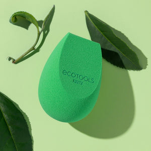 Green teardrop makeup sponge with Ecotools logo, textured foam applicator.