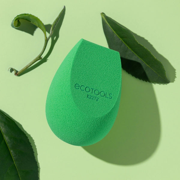 Green teardrop makeup sponge with Ecotools logo, textured foam applicator.