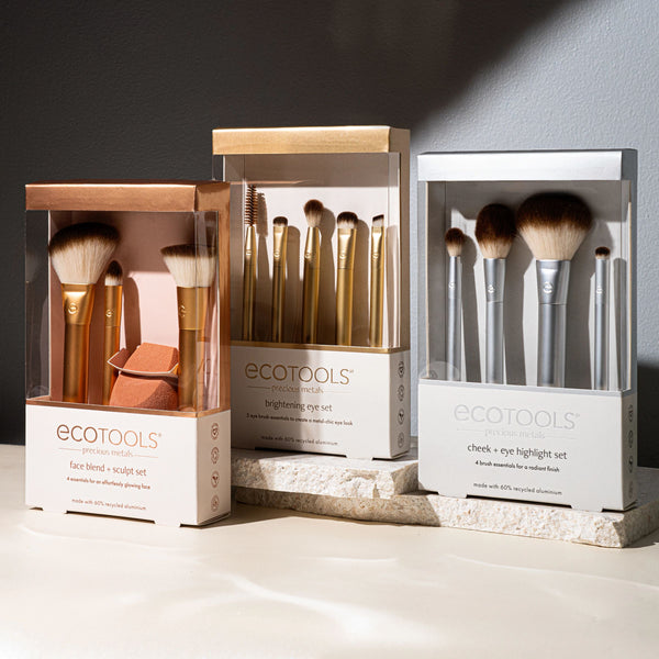 ECOTOOLS face brush set boxes with assorted gold brushes and blending sponge.
