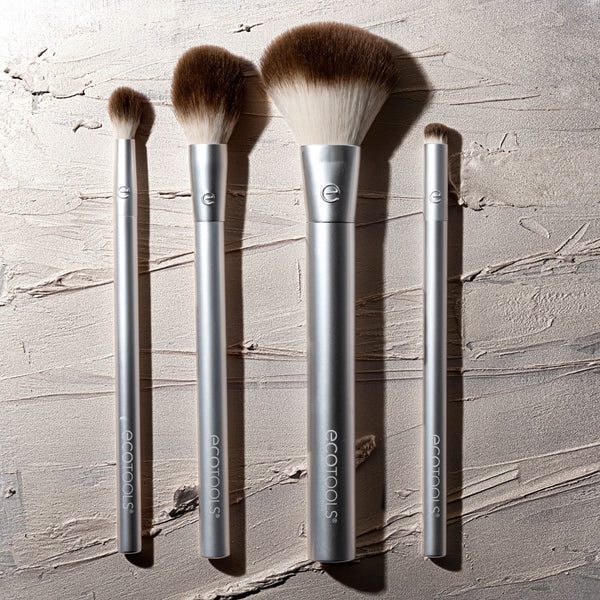 Four silver brushes with brown bristle heads for cheek and eye highlighting