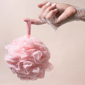 Pink mesh EcoPouf shower scrubber with ruffled loops and hanging tag