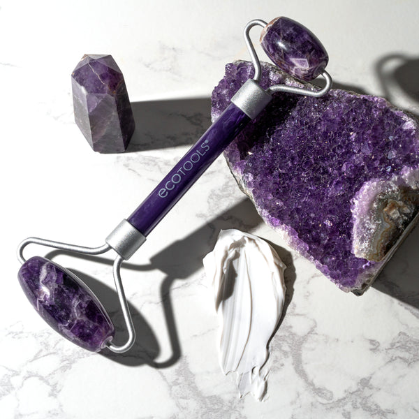 Amethyst facial roller with purple stone heads and silver metal frame