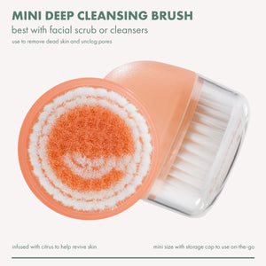 Mini deep cleansing brush with orange scrub dome and white bristles, handheld cap open