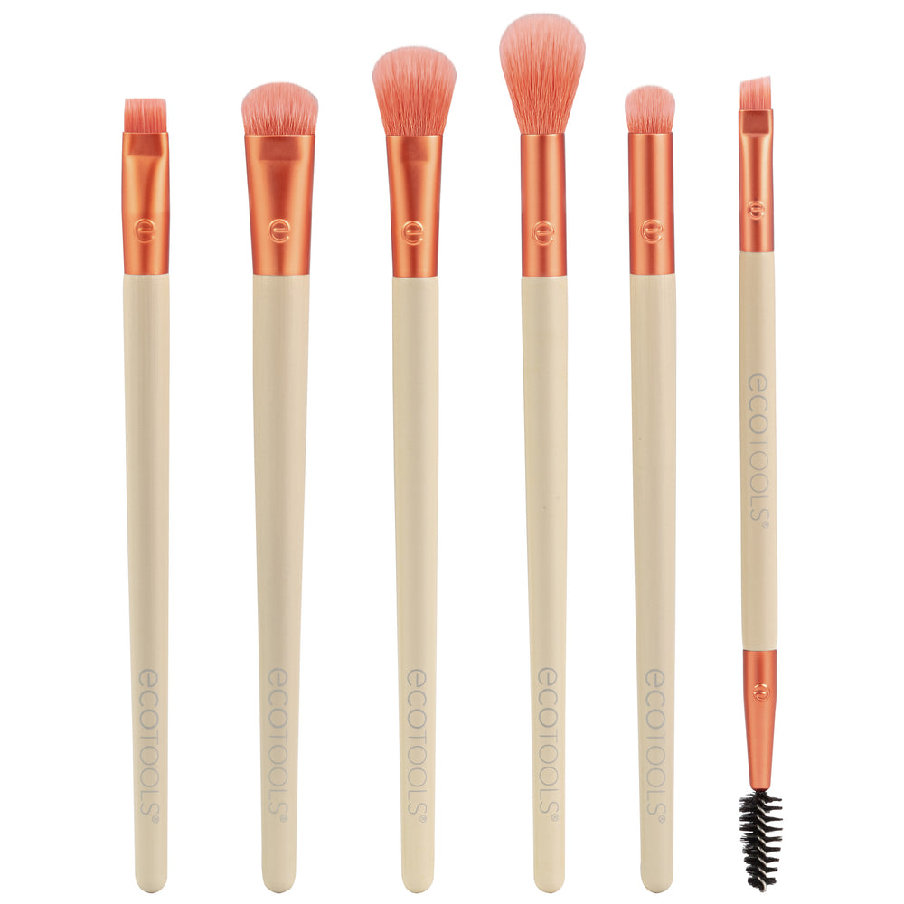 Eye makeup brush set with six peach bristles and beige handles, plus one spoolie wand