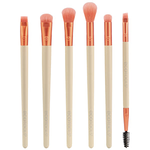 Eye makeup brush set with six peach bristles and beige handles, plus one spoolie wand