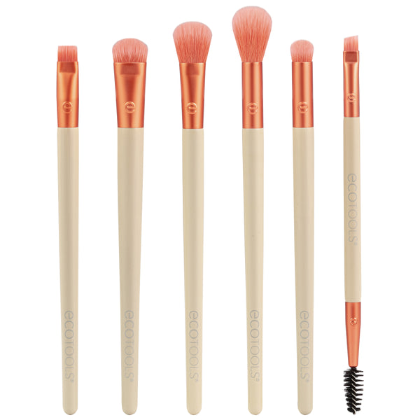 Eye makeup brush set with six peach bristles and beige handles, plus one spoolie wand