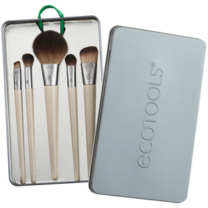 Makeup brush kit: five beige-handled brushes in a gray metal tin case, brown bristles