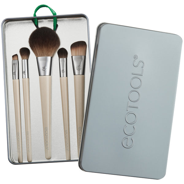 Makeup brush kit: five beige-handled brushes in a gray metal tin case, brown bristles