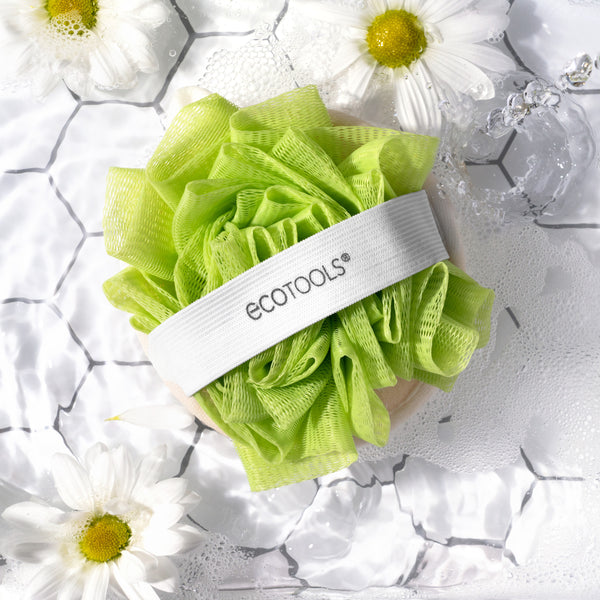 Green cleansing pouf pad with white band and ECOTOOLS logo, loofah-like texture