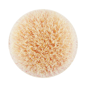 Dry body brush with circular light pink bristle pad and soft-textured fibers