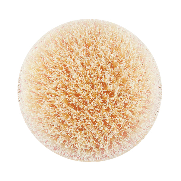 Dry body brush with circular light pink bristle pad and soft-textured fibers