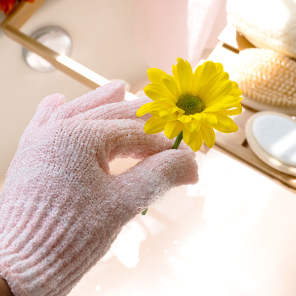 Pink exfoliating bath shower glove close-up with textured knit palm and fingers