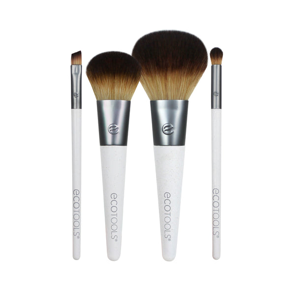 Makeup brush set with 4 brushes, brown bristles, white handles, dark ferrules.