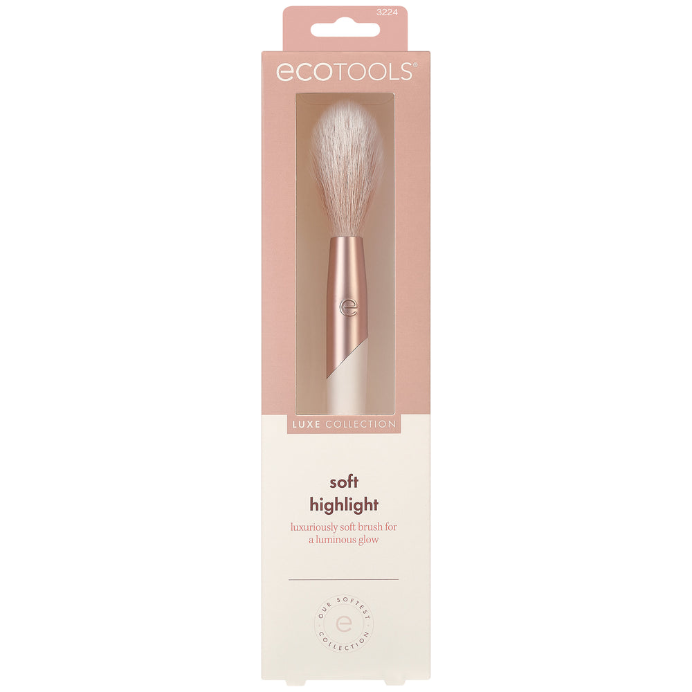 Soft highlight makeup brush with white bristles and rose-gold handle