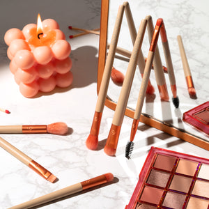 ECOTOOLS elements brush kit brushes laid out with eye shadow palettes on the table