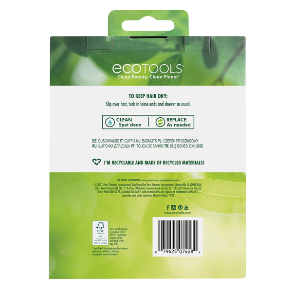 Packaged shower cap with pastel tropical leaf print and eco-style recycling icons