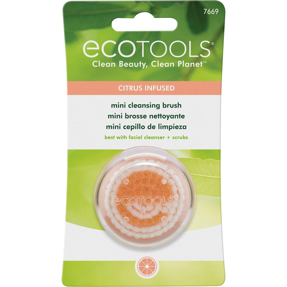 Circular mini cleansing brush head with orange scrub center and white bristles