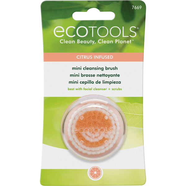 Mini cleansing brush in retail blister pack, shown with an orange scrub dome